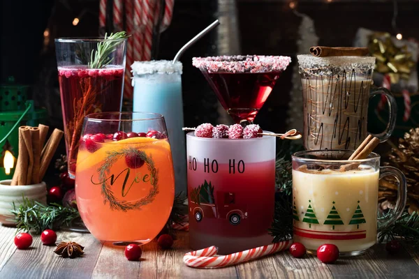 An assortment of Christmas cocktails against a festive dark background. — Stock Photo, Image