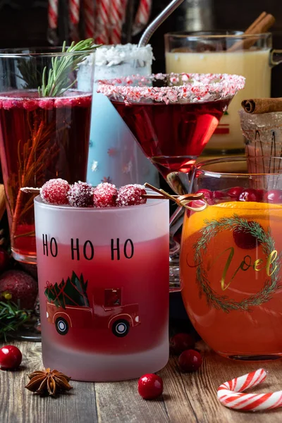 A variety of Christmas cocktails on a wooden table, ready for drinking. — Stock Photo, Image