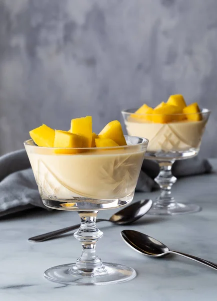 Close up of mango mousse in crystal dessert goblets ready for eating.