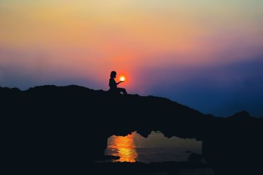 silhouette of person on Beach Rock clipart