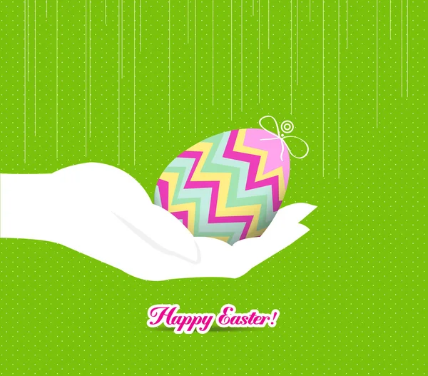 Feliz mano de Pascua sosteniendo un huevo — Vector de stock