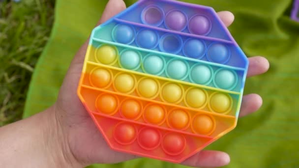 Popular colorful antistress sensory toy Pop It in hands — Stock Video