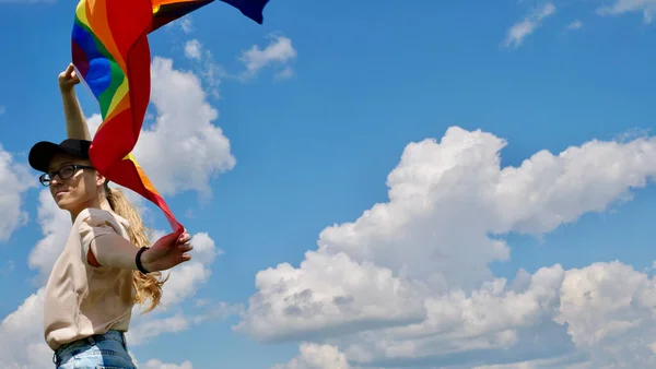 Pessoa segurando bandeira LGBT no fundo do céu — Fotografia de Stock