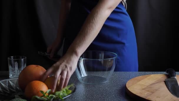 Woman removes lemon zest with a kitchen object — Stock Video