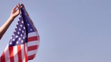 A U.S. flag waves against a clear sky, symbolizing American freedom and patriotism. Its perfect for celebrating Constitution Day and national pride