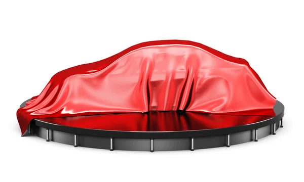 Автомобиль на подиуме, покрытый красной атласной тканью перед презентацией — стоковое фото