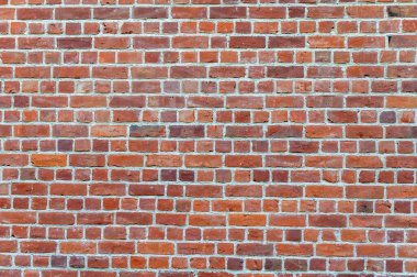 Tasarım projeleri, web siteleri ve editoryal düzenler için şehir dokusu, arkaplan veya mimari detay olarak ideal, pürüzlü havan ve çeşitli tonlara sahip yıpranmış kırmızı tuğla duvar.