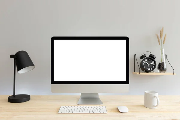 Computer with blank white copy space for text, Mockup design desktop computer in office on wood table with keyboard and Green coffee cub, Lovely black alarm clock.