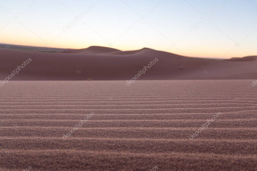 Close-up desert dunes of Erg Chigaga, at the gates of the Sahara, al amanecer. Morocco. Concept of travel and adventur