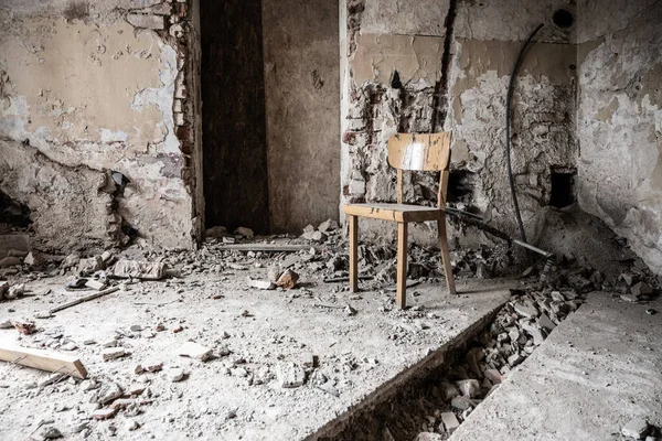 Old wooden chair in devasted abandoned room — Stock Photo, Image