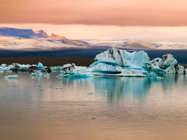 Laguna del ghiacciaio di Jokulsarlon alla luce del sole rossa della sera — Foto Stock