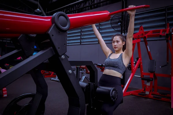 Portrait beauty sport woman wear sportwear posing under exercise with fitness equipment at gym ,she exercise for strong ,make muscle and good healthy