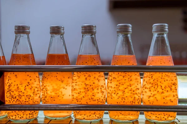 Bottles from Basil seed beverage factory  conveyor belt with bottles for juice or water to distribution in business.