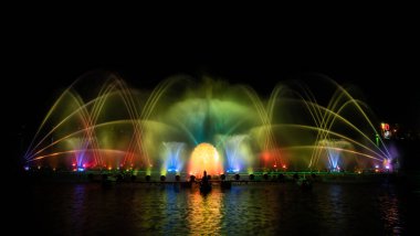 # Yılın kutlaması için dans eden renkli çeşme # # Karanlık gökyüzü arka planıyla #.