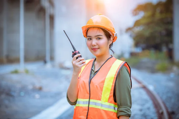 Engineer railway under inspection and checking construction process railway and checking work on railroad station .Engineer wearing safety uniform and safety helmet in work.