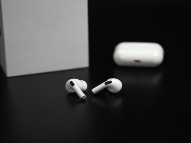 Koyu arkaplanda kablosuz kulaklık, arkaplanda metin için boş alan olan kutu