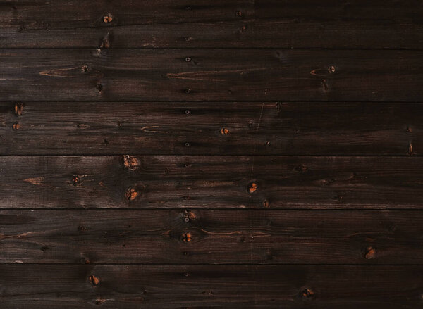 Natural Dark Wooden Background. Wooden rustic background. Old boards. Copy space for your text or image. Top view. Dark brown wood boards. Blank for design and require a wood grain.