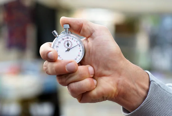 Εκπαιδευτής κρατά χρονόμετρο στο χέρι του και πατάει το κουμπί έναρξης και διακοπής - Close up — Φωτογραφία Αρχείου