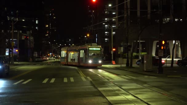 SEATTLE, USA - FEBRUARY 4, 2021: Tram, Road and Cityscape at Night — Stock Video