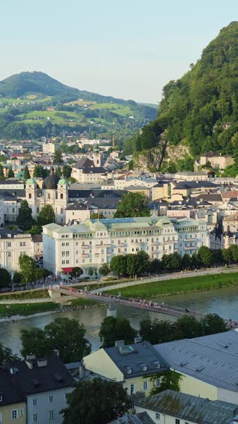 Salzburg Old Town on Sunny Summer Evening. Salzach River and Tourists on Bridge. Austria. Vertical Video Salzburg Old Town on Sunny Summer Evening. Salzach River and Tourists on Bridge. Austria. Vertical Video