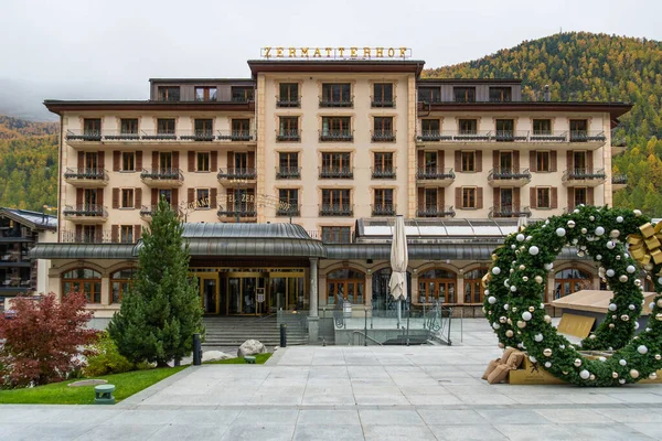 ZERMATT, SWITZERLAND - OCTOBER 20, 2025: Closed for Season Grand Hotel Zermatterhof in Autumn on Cloudy Day. Zermatt, Valais, Switzerland