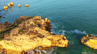 Headland, Cliffs, Sea Stacks. Coastline and Atlantic Ocean on Sunny Day. Aerial Shot. Algarve, Portugal. Drone Moves Backwards and Upwards