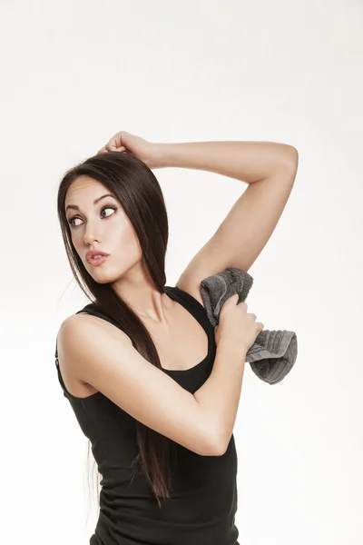 Woman wiping her underarm pits with towel