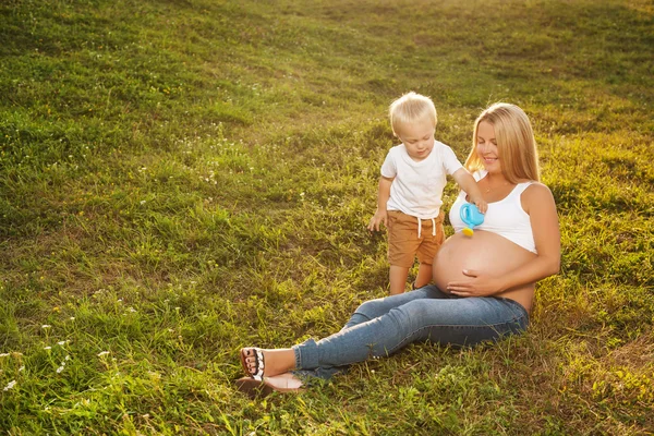 Milý chlapeček, zalévání břicho matky — Stock fotografie