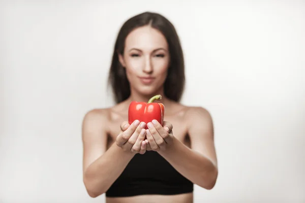 Portrait of young fit woman holding bell pepper — Stock Photo, Image