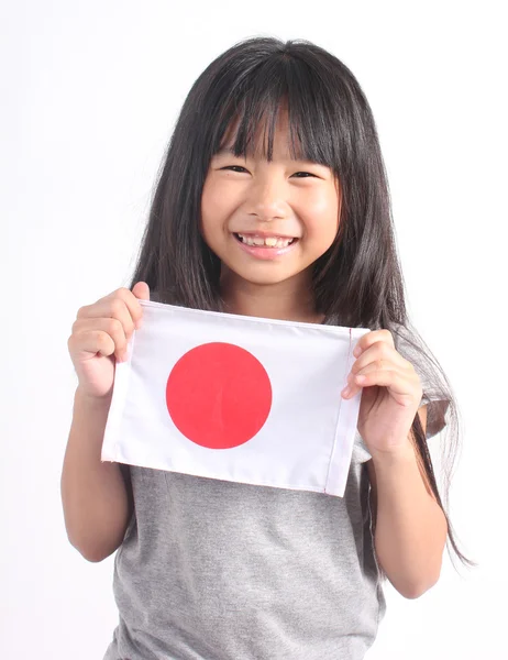 Menina bonito segurando bandeira japonesa — Fotografia de Stock