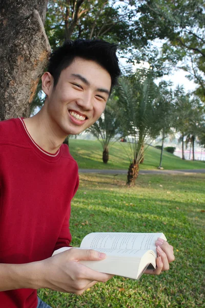 Joven leyendo en el parque — Foto de Stock