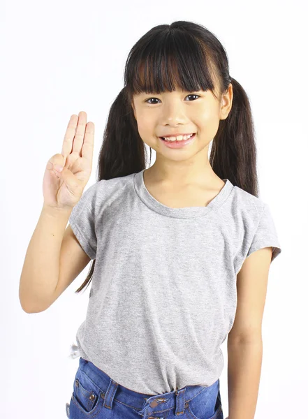 Portrait of young cute girl posting with three fingers. Stock Photo