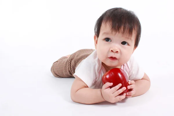 Cute baby with red apple (eating healthy food) — Stock Photo, Image