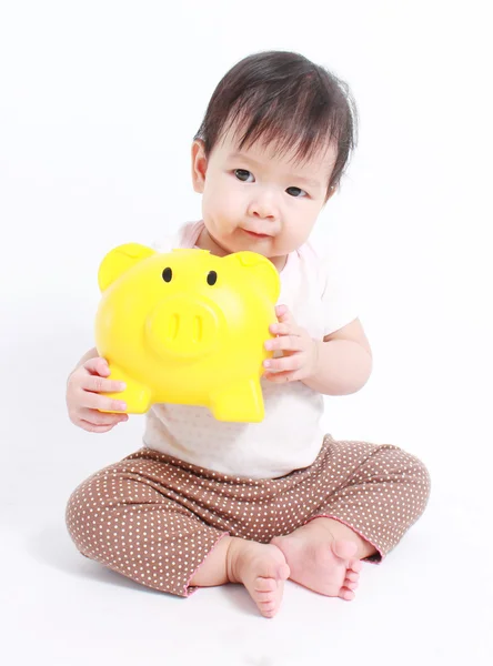 Bebê bonito com banco porquinho — Fotografia de Stock