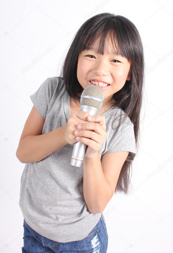 Pretty little girl with the microphone in her hand