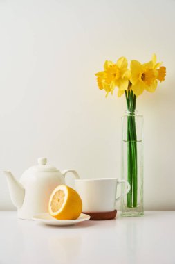 Çaydanlık, fincan ve çiçekler beyaz arkaplanda