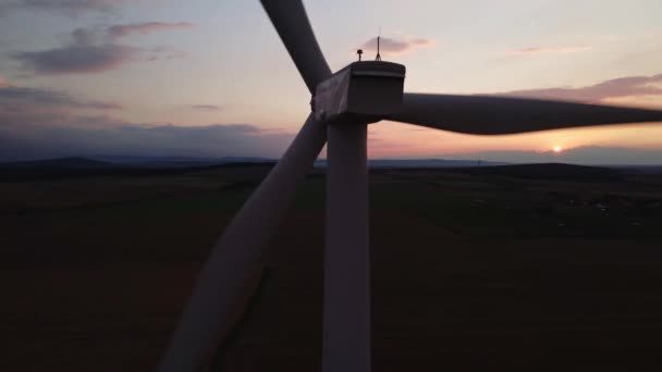 Silhouette de turbine éolienne dans le champ au coucher du soleil. Générateur éolien rotatif — Video