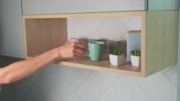 Woman take cup from open kitchen cupboard — Stock Video