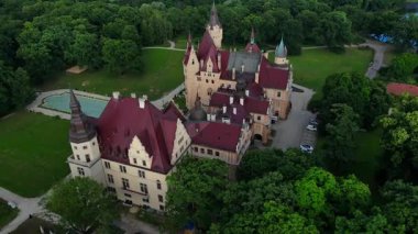 Moszna castle near Opole in Poland. Aerial view of historic castle surrounded by green park. European heritage and architecture