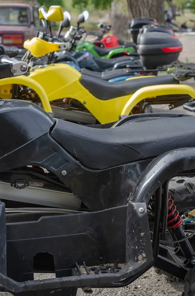 Group of random quad bikes in  line outdoors. Rent of transport for off road trips. Active rest, adventure.