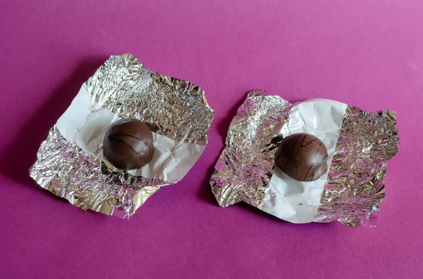 Dwie Rozpakowane Czekoladowe Cukierki Różowym Tle Para Pysznych Słodyczy Koncepcja — Zdjęcie stockowe