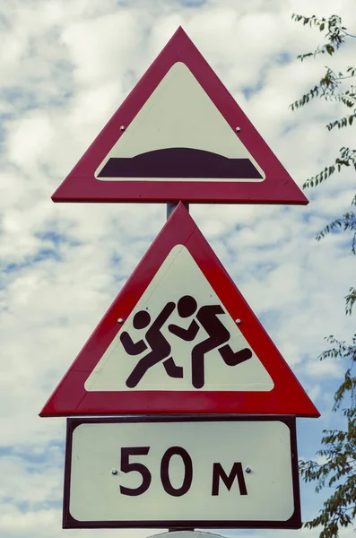 Red-white road signs against the dramatic sky. Three road signs vertically on one pole. Road safety concept. Without anybody. — Stock Image Red White Road Signs Dramatic Sky Three Road Signs Vertically Stock Image