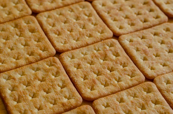 Kare tuzlu krakerler, arka plan. Yakın plan çıtır kraker..