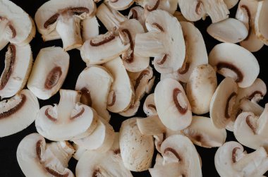 Bir grup ham şampiyon siyah arka planda parçalara ayrıldı. Yiyecek, malzeme..