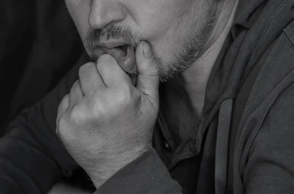 Body language  concept. Black and white portrait of an adult man supporting his head with fist. Middle-aged man in  bored posture.