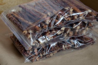 Packs of the dried bovine penis for pets. Natural healthy chewable treats for tartar removal. Premium quality pet products.