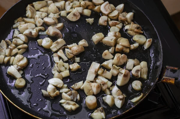 生のキノコはフライパンで揚げられます 薄切りのキノコは油で揚げられる 選択的フォーカス — ストック写真