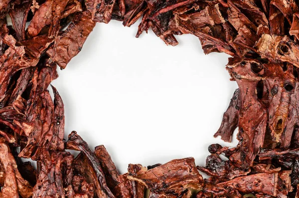 Natural treats for pets. Dried beef lungs with the blank white area. Full frame of dried treat pieces with copy space in the center.  Beef jerky for dogs. Top View, Flat Lay