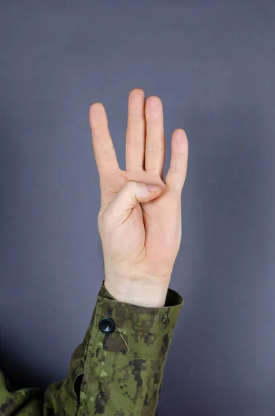 Hand Camouflage Shows Gesture His Fingers Gray Background Four Fingers — Stock Photo, Image