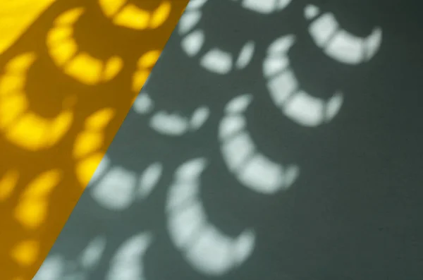 Minimalist light and shadow composition on yellow and blue. Abstract sunspots on a two-color background.